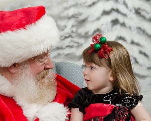 Little Girl's twinkle with Santa