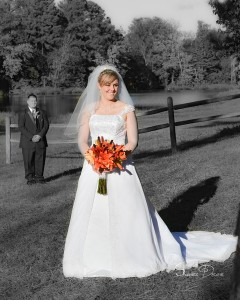 Bride and Groom near lake in park.